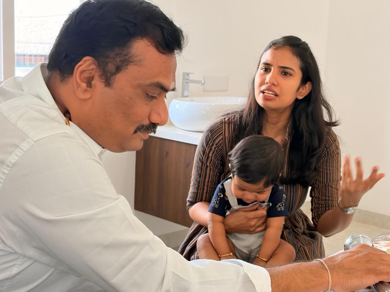 A mother describing her baby's week while Dr. Ramani listens