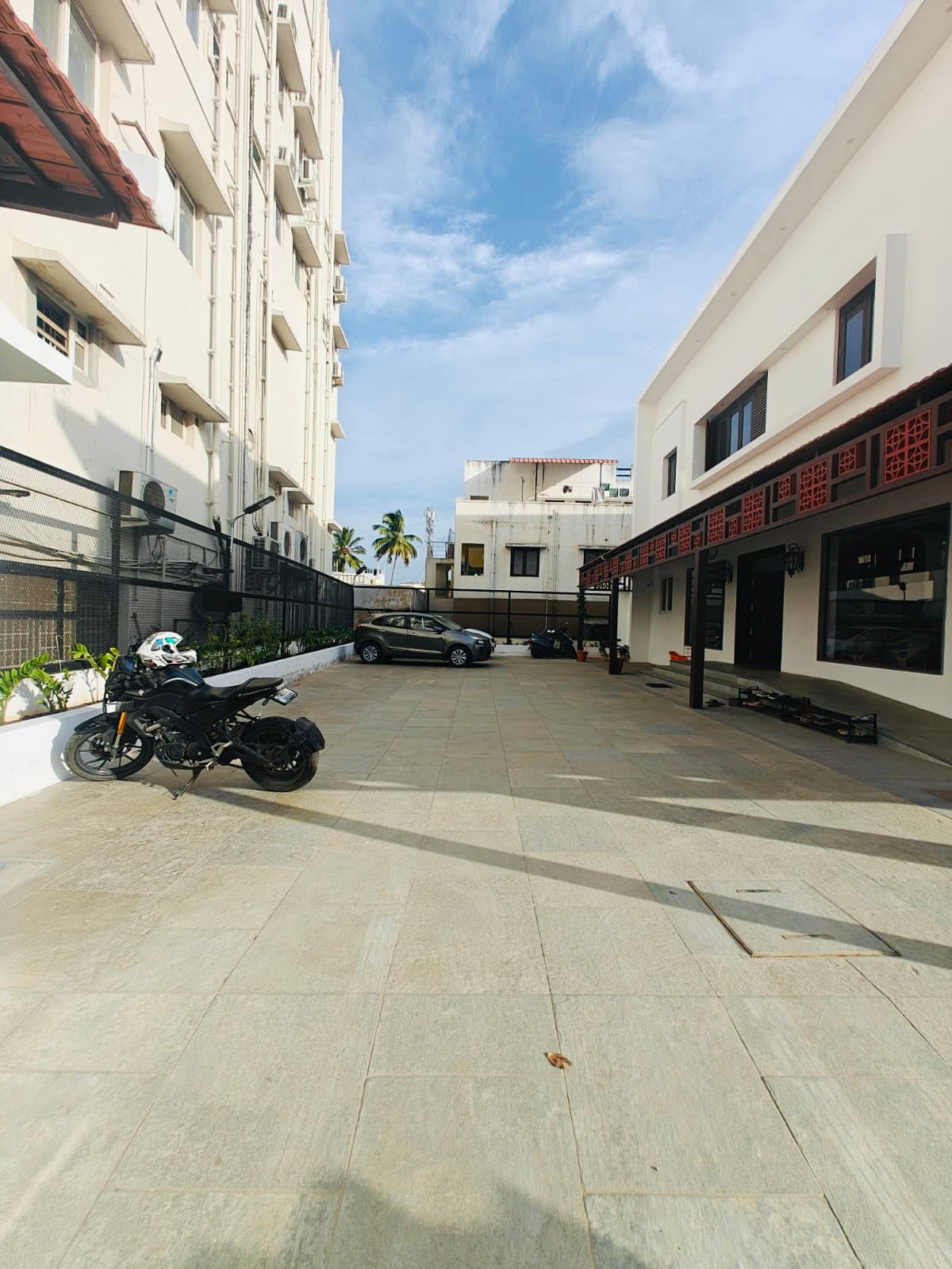 The paved courtyard with parking, looking back at the tiled veranda