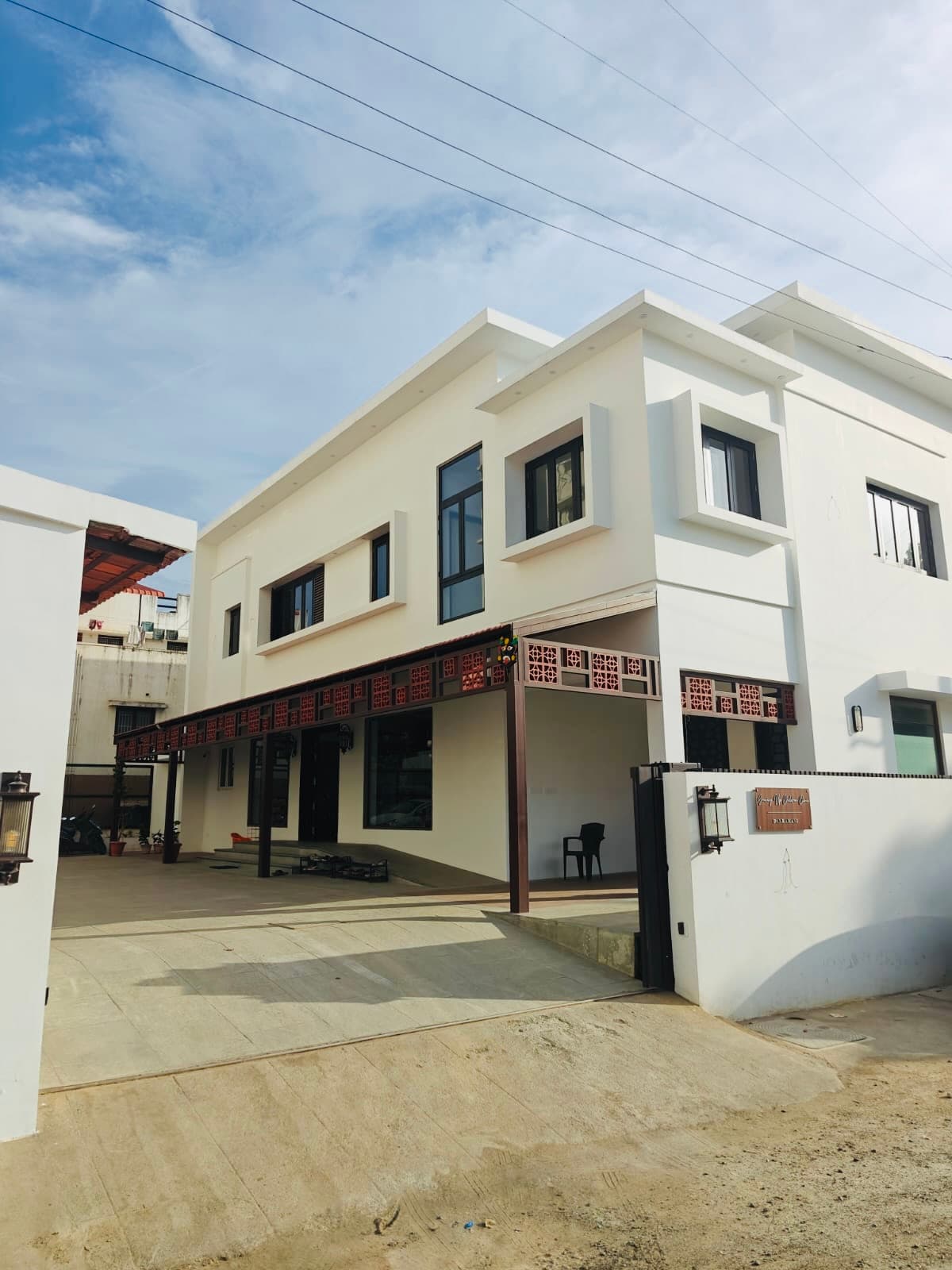 The clinic from the driveway, the gate standing open onto the courtyard