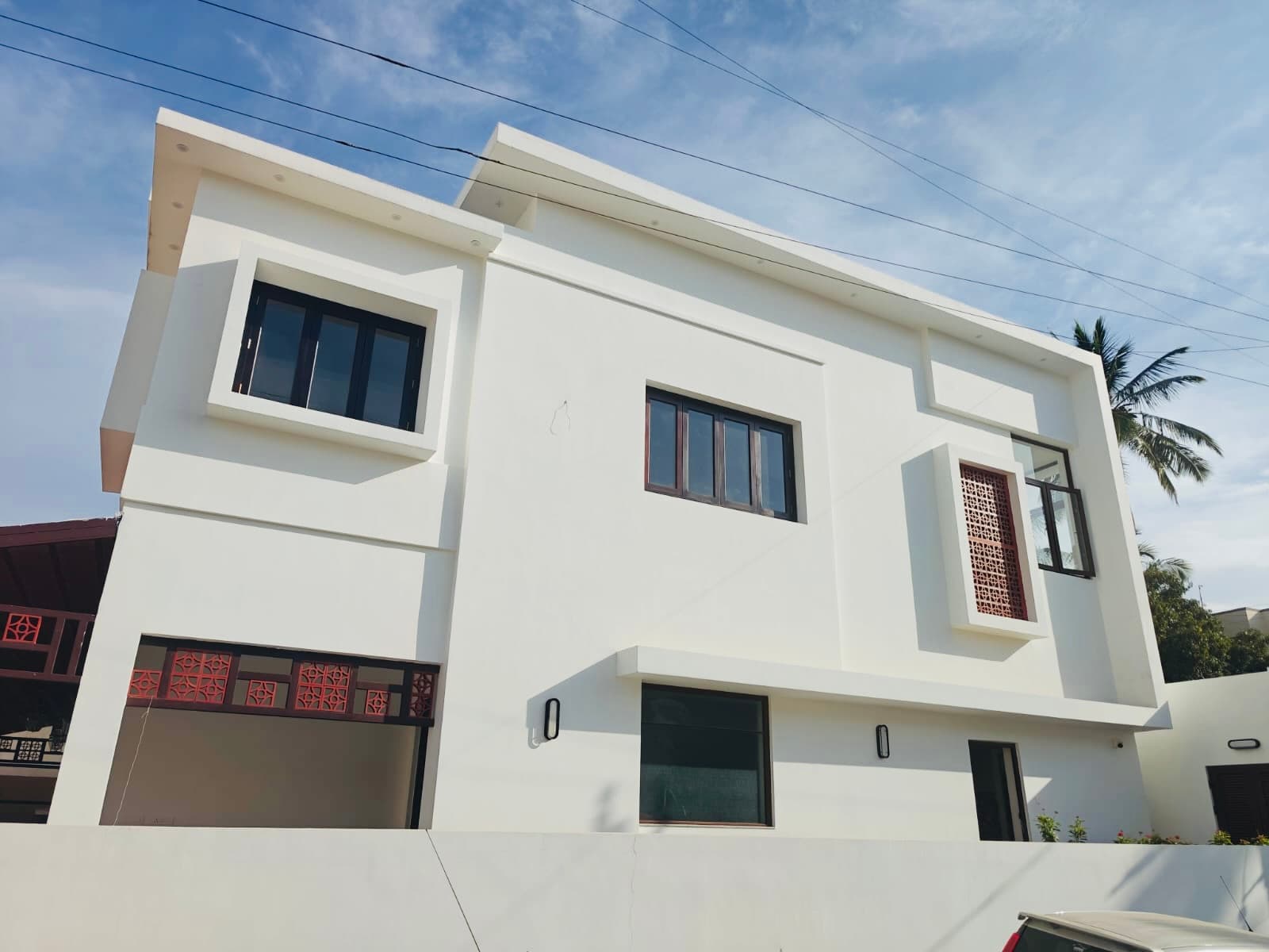 The side elevation, a terracotta jaali panel set into white render