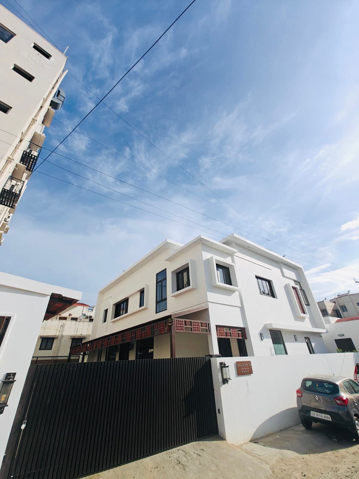 The clinic under an open sky, seen from the far corner of the courtyard