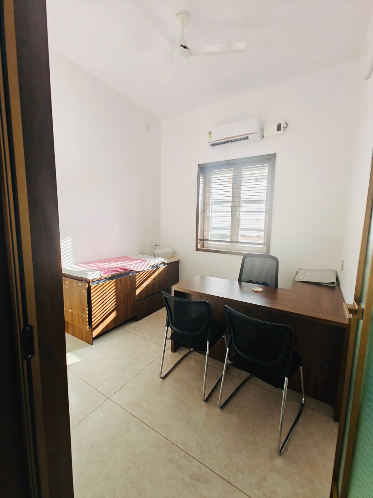 The second consulting room, desk and examination bed ready for an older child's visit